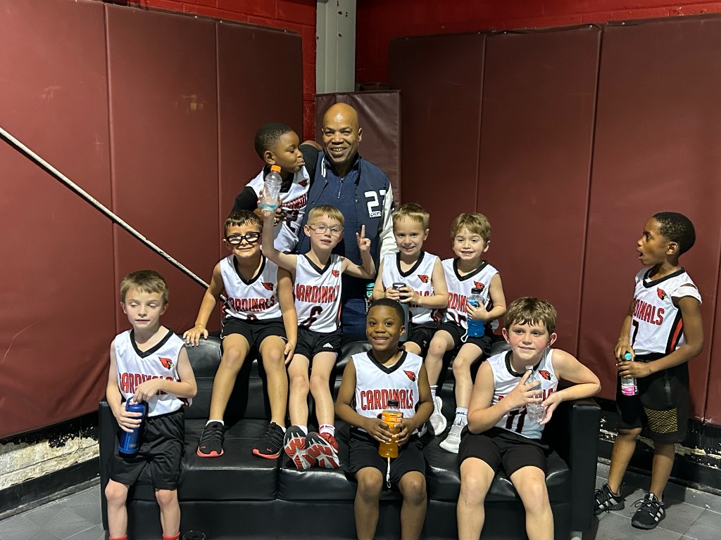Sean Johnson standing with the Cardinals youth basketball team